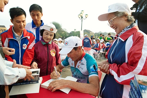 Đến đâu, Patrick Farmer cũng ký tặng sách cho dân địa phương và du khách.