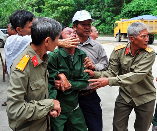 Trên hành trình về chiến trường xưa, ông Nguyễn Văn Việt - người duy nhất sống sót trong trận tập kích vào sân bay Khâm Đức nhiều lần bị co giật, lả người trong vòng tay đồng đội. Ảnh: NGUYÊN ĐOAN