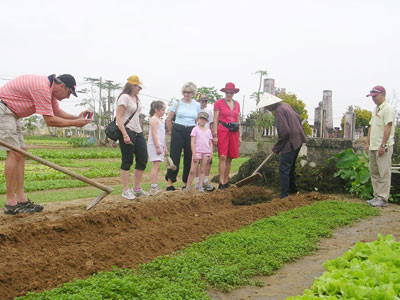 Du khách tham quan làng rau Trà Quế và làng quê sông nước Cẩm Thanh.Ảnh: ĐỖ HUẤN