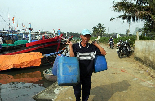 Ngư dân xã Tam Tiến dùng can mua xăng dầu chuẩn bị đối phó với những ngày bão..