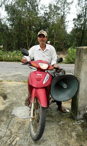  Cán bộ chính quyền xã dùng loa di động thông tin liên tục về hướng di chuyển của bão Haiyan.