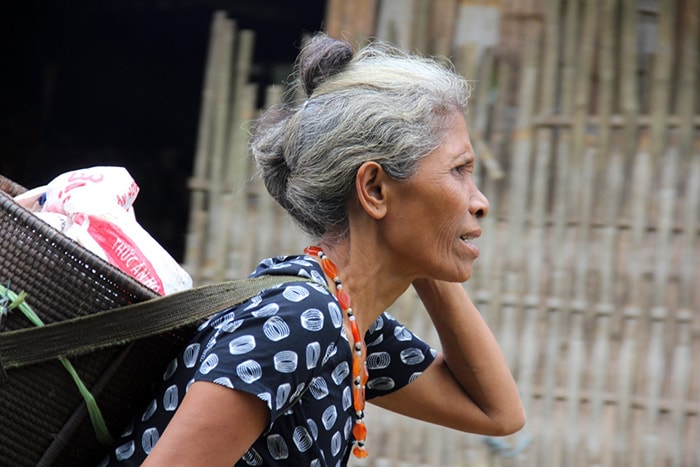 Bà Đinh Thị Miên, ở thôn Bút Tưa (xã Sông Kôn) hớn hở gùi gạo tết về nhà.