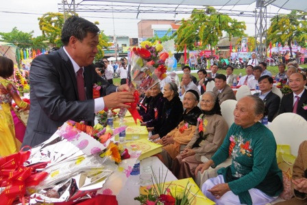    Lãnh đạo huyện trao tặng hoa và quà cho Bà mẹ VNAH. Ảnh: Bích Liên
