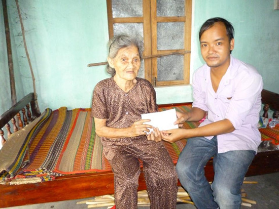 Anh Nguyễn Thành Giang (bìa phải) trao quà của các nhà hảo tâm cho một trường hợp khó khăn. Ảnh: C.NỮ