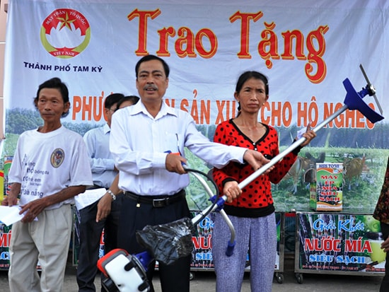 Lãnh đạo Ủy ban MTTQ TP.Tam Kỳ trao phương tiện sản xuất cho người nghèo.  Ảnh: VINH ANH