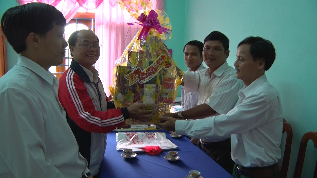 Chủ tịch Công đoàn báo Quảng Nam Đoàn Ngọc Anh tặng quà tết cho UBND xã Trà Kót. Ảnh: XUÂN THỌ