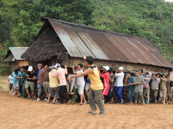 Tuổi trẻ thôn Achiing, xã A Tiêng (Tây Giang) giúp dân dời nhà về nơi ở mới. Ảnh: LÊ THIÊN NGÂN