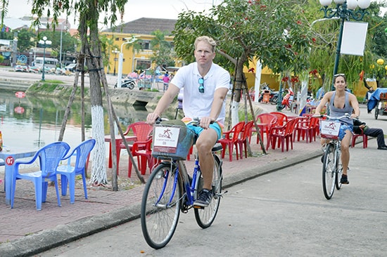 Foreign tourists cycling in Hoi An city