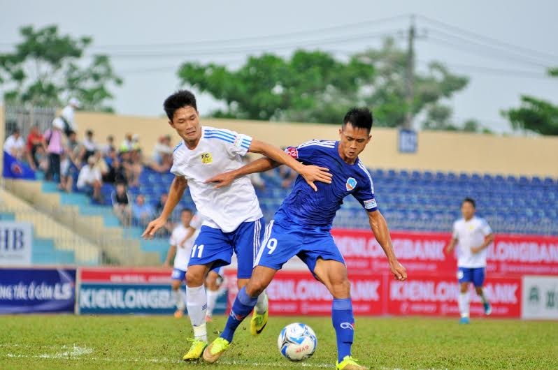 Tiền đạo Minh Tuấn (bên phải) của QNK Quảng Nam tranh chấp với Công Nhật của Huế. Ảnh: T.V