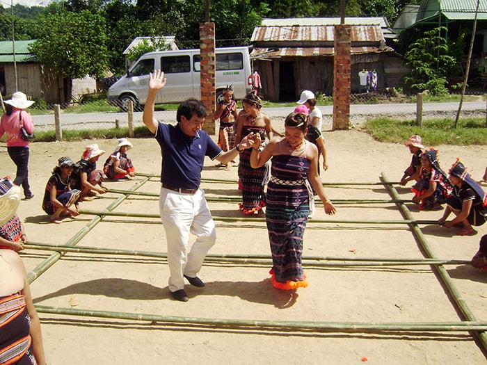 Tourists in a Co Tu traditional dance in Nam Giang district