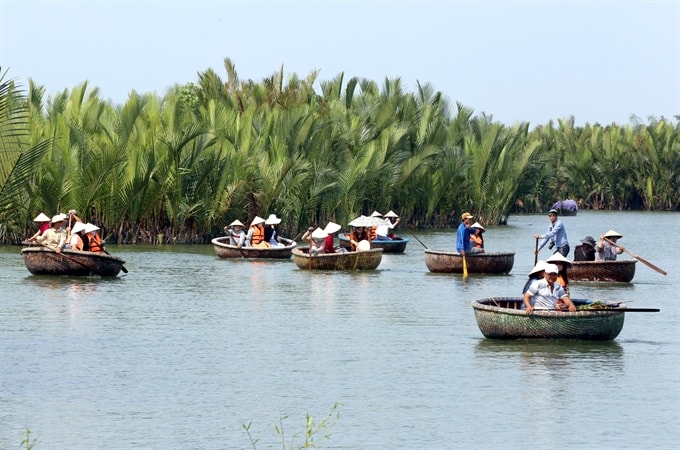 Tourists enjoy riding basket boats in Cẩm Thanh water coconut village. Prime Minister Nguyễn Xuân Phúc yesterday affirmed the Government’s commitment to create smooth conditions for investors and ensure that investors benefit when investing in Việt Nam. — VNA/VNS Photo Trần Lê Lâm