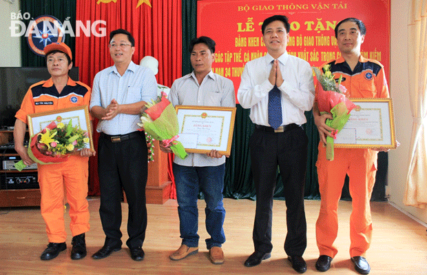 Thứ trưởng Bộ GTVT Nguyễn Ngọc Đông (thứ 2, phải qua) và Phó Chủ tịch UBND tỉnh Quảng Nam Lê Trí Thanh tặng bằng khen cho các tập thể, cá nhân.