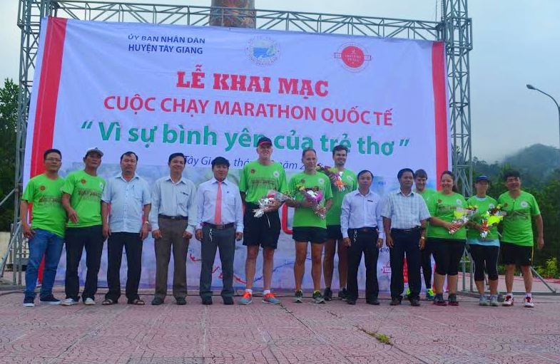 Lãnh đạo huyện Tây Giang tặng hoa cho các VĐV người nước ngoài, tại Lễ khai mạc chương trình chạy Marathon – 2016; Ảnh: PHỤNG