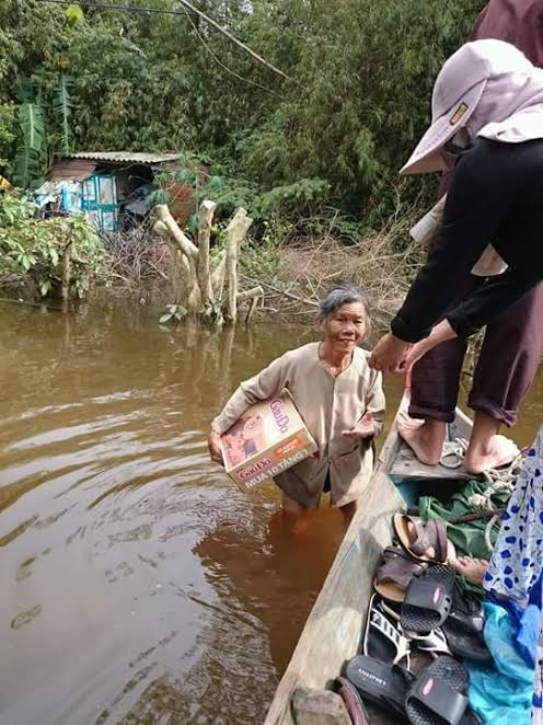 Niềm vui của người dân vùng ngập lụt khi nhận quà cứu trợ.