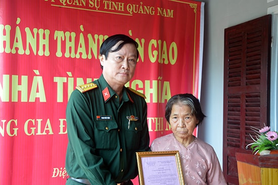 Đại tá Phạm Xuân Thiện, Phó Chỉ huy trưởng-Tham mưu trưởng Bộ CHQS tỉnh trao quyết định bàn giao nhà cho bà Lê Thị Mỵ.