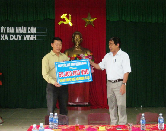 Ông Nguyễn Văn Long trao tặng số tiền 50 triệu đồng cho đại diện lãnh đạo xã Duy Vinh.