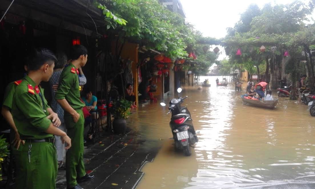 Lực lượng chức năng trực tại các điểm ngập lụt để khuyến cáo đảm bảo an toàn đi lại