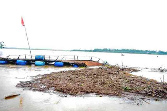 Cây cầu phao đã gãy đôi chìm sông, trôi gần hết thùng phuy, thiệt hại cả trăm triệu đồng. Ảnh: TRIÊU NHAN