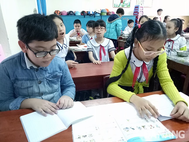 Nhiều trẻ em bị cận thị do đọc sách trong điều kiện ánh sáng không bảo đảm.