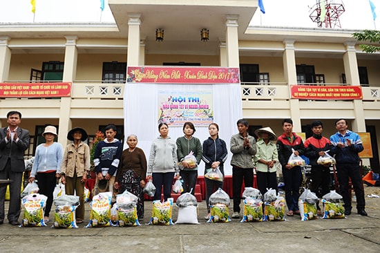 Trạo tặng quà, tiền và bánh tét cho người nghèo tại xã Cẩm Thanh. Ảnh: MINH HẢI