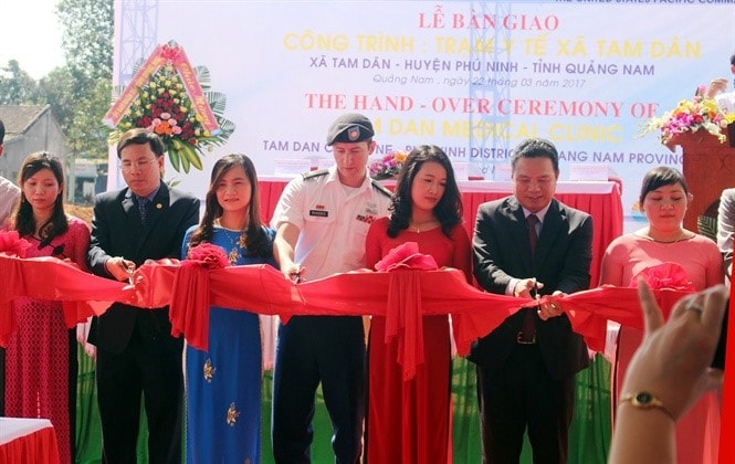 Representatives of both parties cut ribbons in the hand-over ceremony