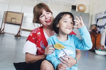 Ms. Jackie and a kid at the Ky Anh centre.