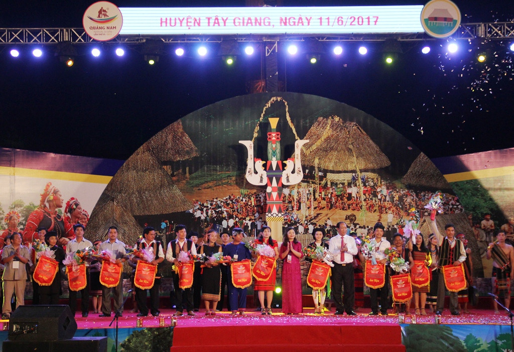 Đại diện lãnh đạo tỉnh và địa phương Tây Giang tặng hoa và cờ lưu niệm cho các đoàn tham gia ngày hội.