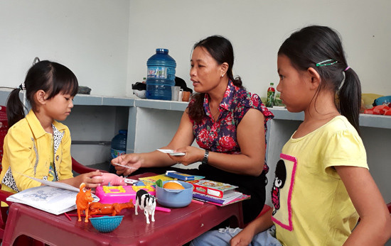Cô Lê Thị Ánh Tuyết - Trưởng ban đại diện cha mẹ trẻ khuyết tật xã Bình Nguyên đang dạy cho các em khuyết tật bị câm, điếc. Ảnh: Biên Tân