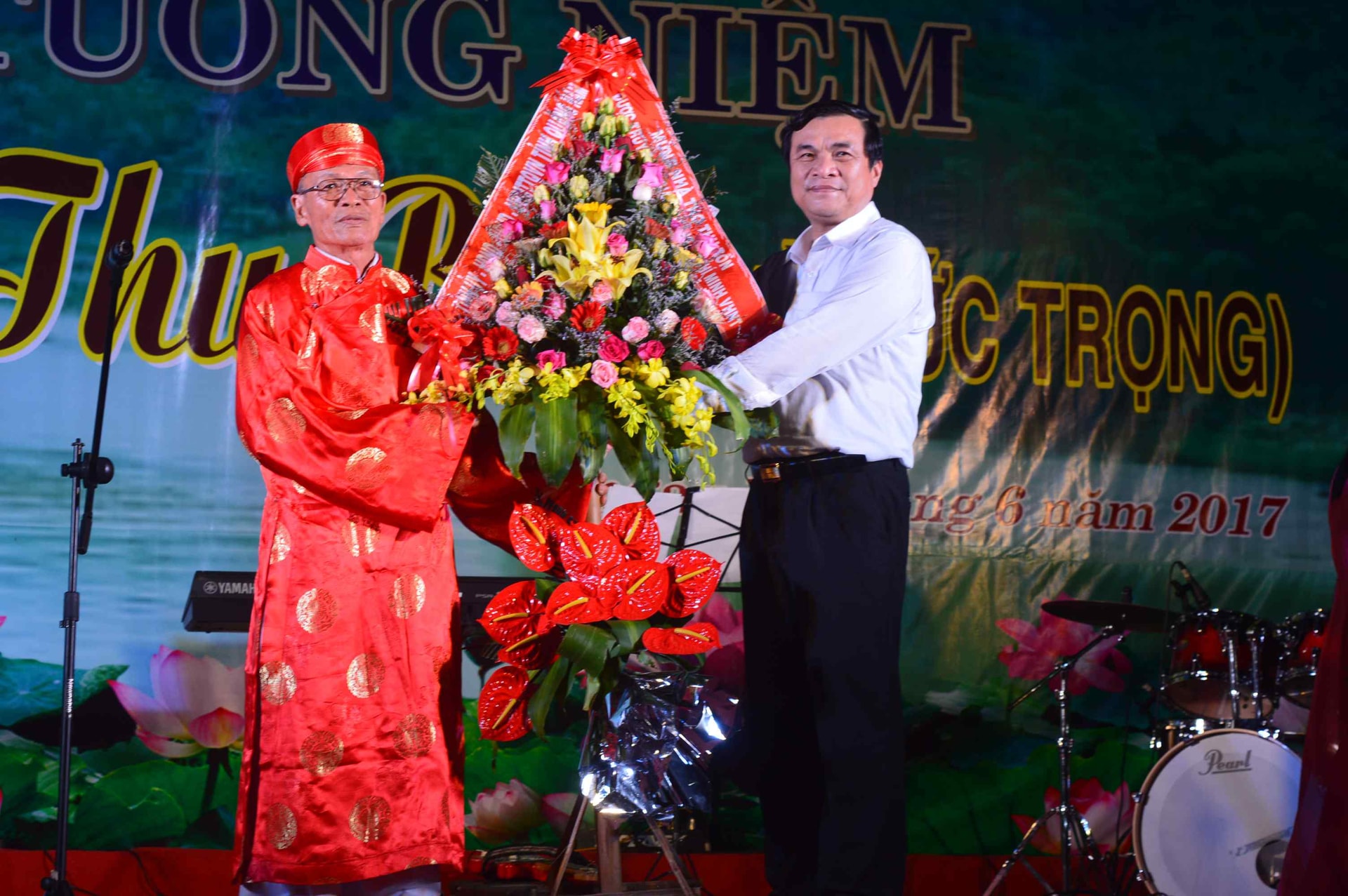 Lãnh đạo tỉnh tặng hoa chúc mừng gia tộc Hà Đức của nhà thơ Thu Bồn. Ảnh: Q.T