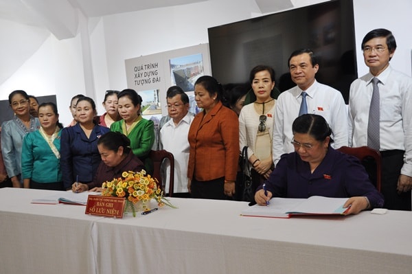 Ảnh: Phó Chủ tịch Quốc hội Việt Nam Tòng Thị Phóng và Phó Chủ tịch Quốc hội CHDCND Lào Xi-xảy Lư-đêt-mun-xỏn viết sổ lưu niệm. Ảnh: N.Đ