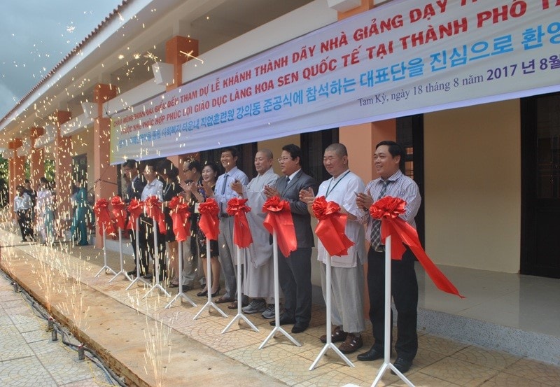 Cutting red ribbon to open school