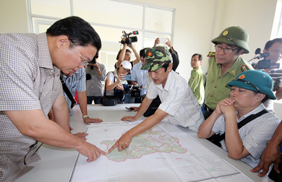 Phó Chủ tịch UBND tỉnh Lê Trí Thanh xem bản đồ quy hoạch rừng Tiên Lãnh. Ảnh: P.VINH