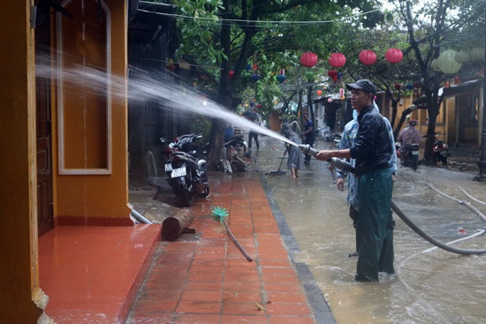 Tranh thủ dọn dẹp trên đường Nguyễn Thị Minh Khai khi nước rút
