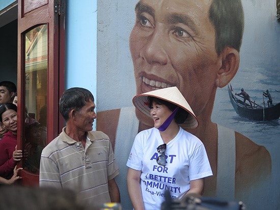 Mrs. Kim Jung Sook is talking to one of the characters in the murals