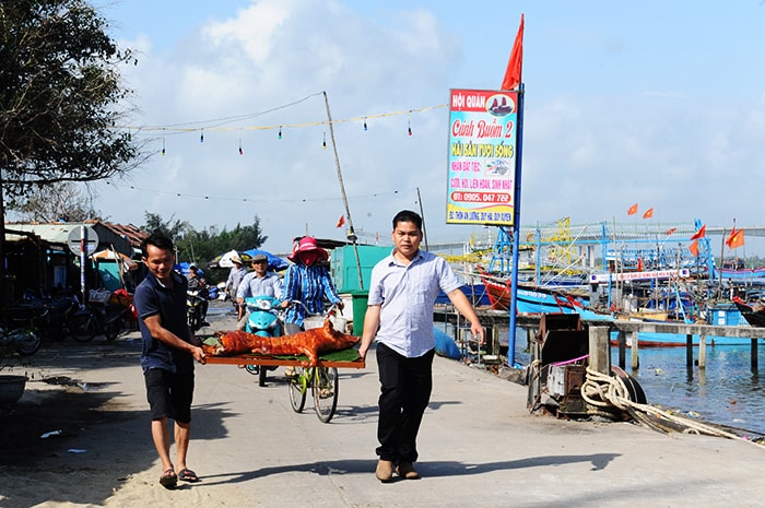 Dân lễ vật lên đàn cầu ngư. Ảnh: MINH HẢI