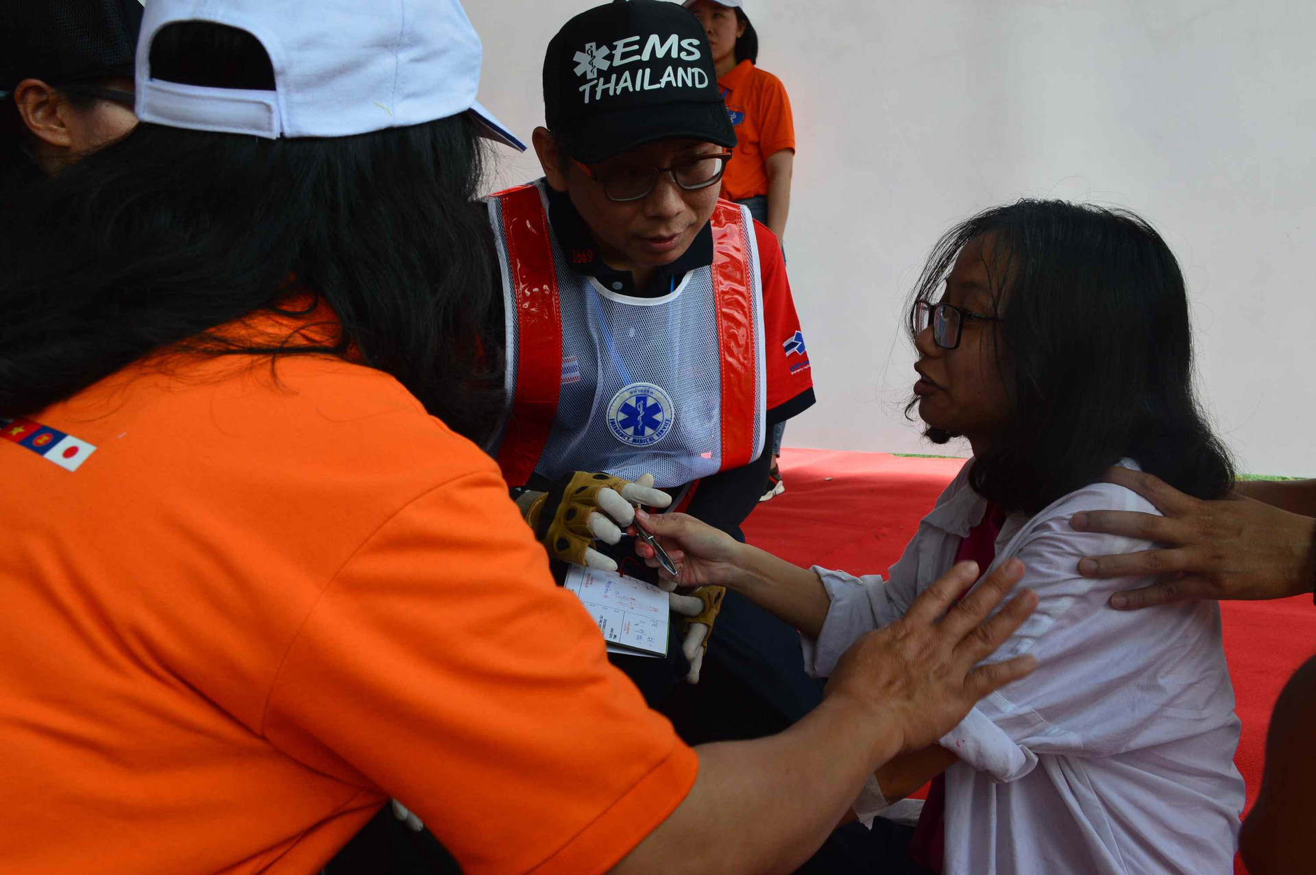Các thành viên của đội cứu hộ Thái Lan lấy thông tin từ một bé gái bị nạn trong thảm họa để đưa đi cấp cứu. Ảnh: Q.T