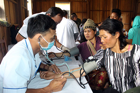 Đội ngũ y, bác sĩ quân đội tiến hành khám bệnh, cấp thuốc cho nhân dân Lào.
