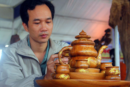 Nguyễn Văn Ân và bộ tách trà Trúc Quảng vừa được UBND tỉnh vinh danh Sản phẩm công nghiệp nông thôn tiêu biểu. Ảnh: LÊ QUÂN