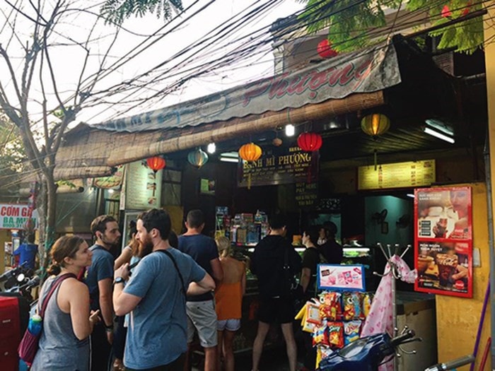 Tourists queue to buy bread in Hoi An.