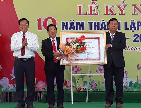 Lãnh đạo huyện Quế Sơn trao Bằng khen của Chủ tịch UBND tỉnh cho xã Hương An vì thành tích xuất sắc trong phong trào thi đua. Ảnh: D.T