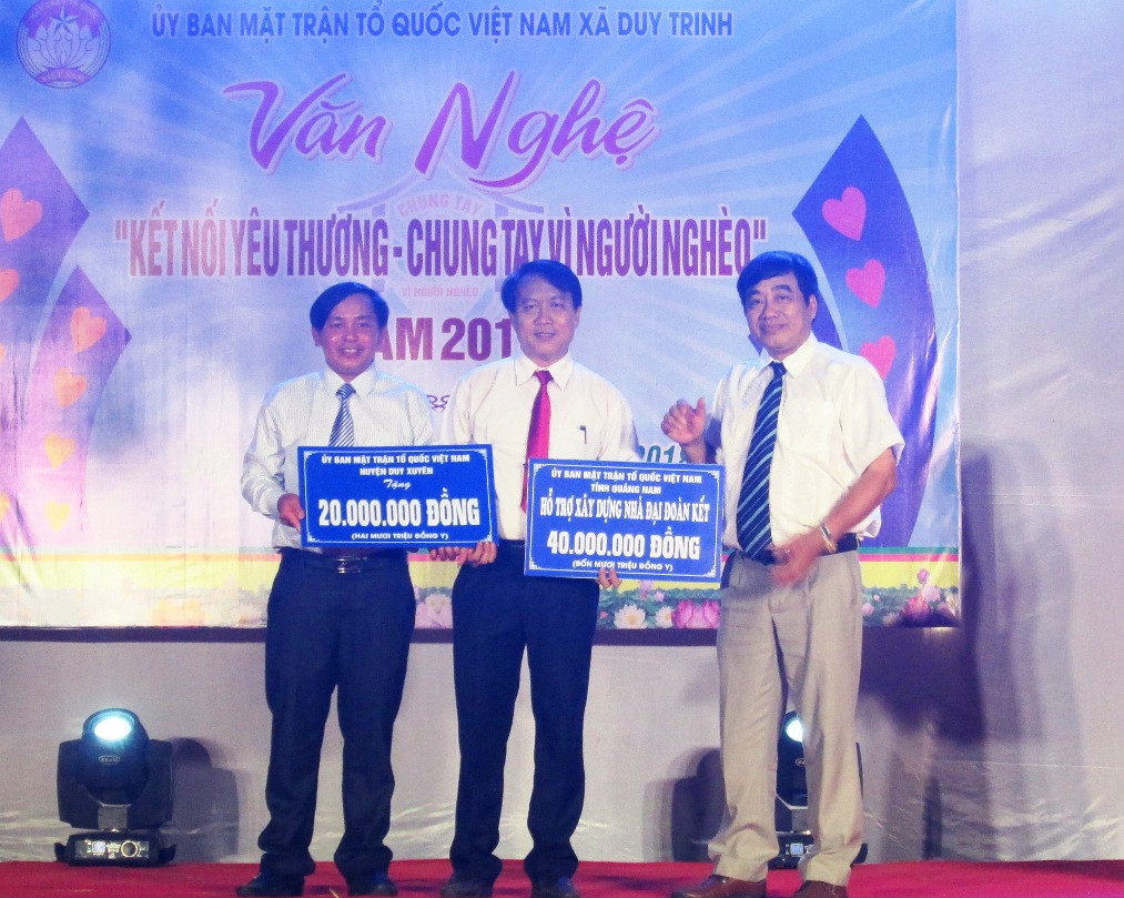 Lãnh đạo Ủy ban MTTQ Việt Nam tỉnh và huyện Duy Xuyên trao số tiền 60 triệu đồng hỗ trợ xóa nhà tạm cho xã Duy Trinh.  Ảnh: HOÀI NHI