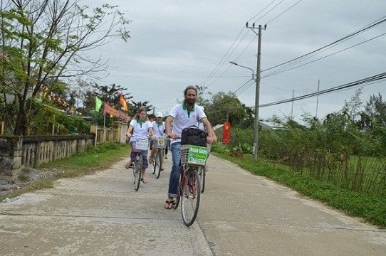 Foreign tourists riding bicycles in Hoi An city