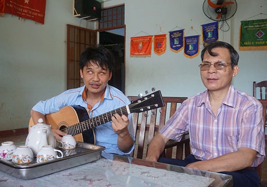 Nguyễn Minh Tuấn đang chơi đàn guitar. Ảnh: Giang Biên