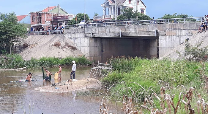 Nhiều người dân dùng lưới tìm kiếm khu vực suối. Ảnh. T.T