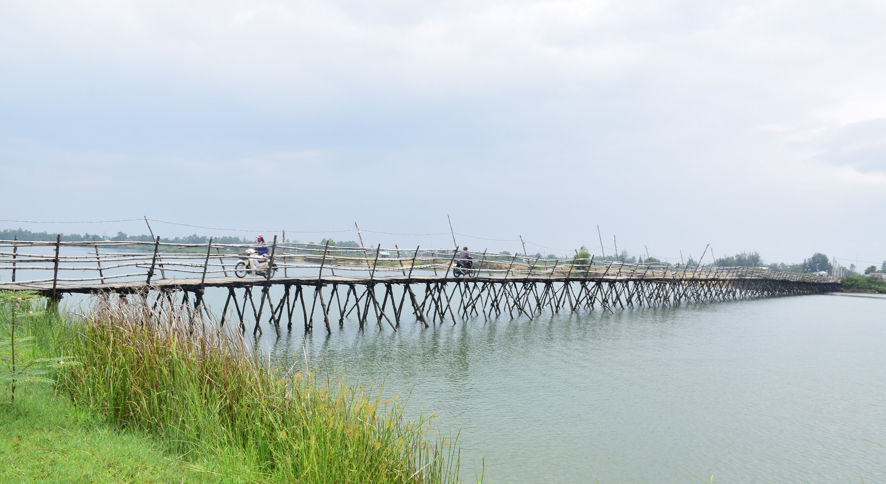 Cây cầu tạm bằng gỗ được được xây dựng gần nửa tỷ đồng với chiều rộng 2.5m, dài 200 m) phục vụ việc đi lại tạm thời của 13.000 người dân địa phương. Cây cầu này chỉ sử dụng được mùa nắng, vào mùa mưa nước sông dân cao cầu sẽ bi cuốn trôi.Ảnh: THANH THẮNG