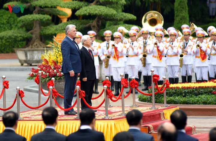 Tổng Bí thư, Chủ tịch nước Nguyễn Phú Trọng mời Chủ tịch HĐNN và HĐBT Cuba Miguel Diaz Canel bước lên bục danh dự. Quân nhạc cử quốc thiều hai nước.