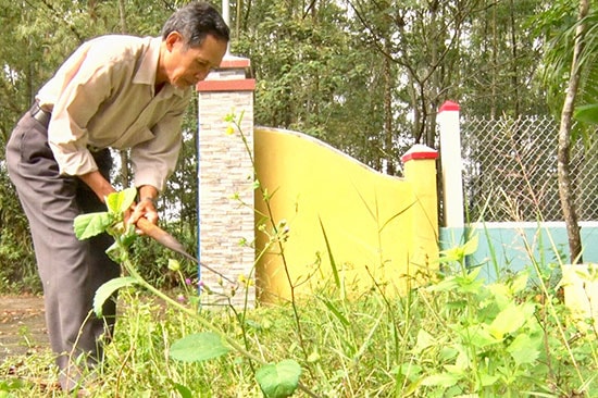 Ông Đoàn Ngọc Hùng - Trưởng ban Công tác mặt trận thôn Dương Đàn phát quang bụi rậm ở khu dân cư. Ảnh: V.CÔNG