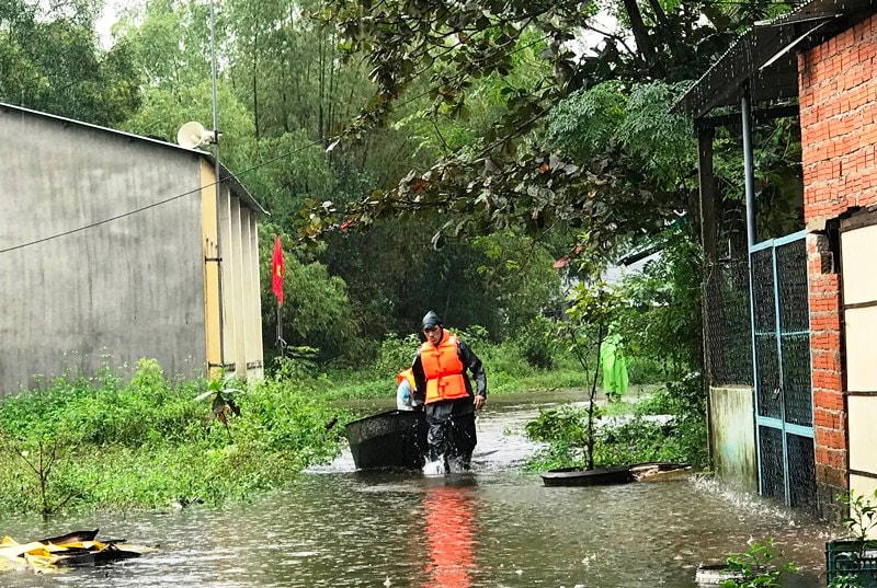 Lực lượng chức năng đưa người dân ra khỏi vùng nguy hiểm. Ảnh:VINH ANH