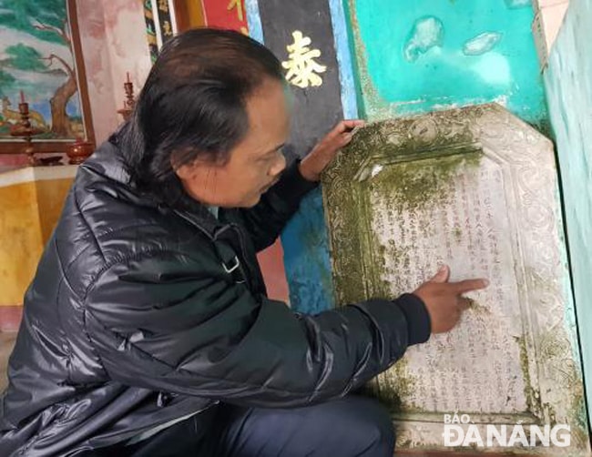 Ông Đỗ Hữu Thanh tự hào giới thiệu bia lịch sử đình làng Thái Lai. Ảnh: T.T