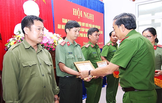 Đại tá Trần Mưu - Phó Giám đốc Công an TP.Đà Nẵng trao thưởng cho các tập thể, cá nhân của Quảng Nam có đóng góp xuất sắc vào công tác phối hợp giữa hai đơn vị trong bảo đảm an ninh trật tự. Ảnh: T.C